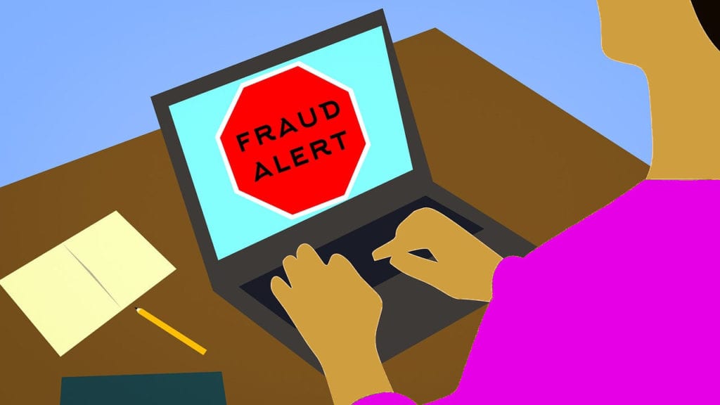 illustration of fraud alert warning on laptop screen